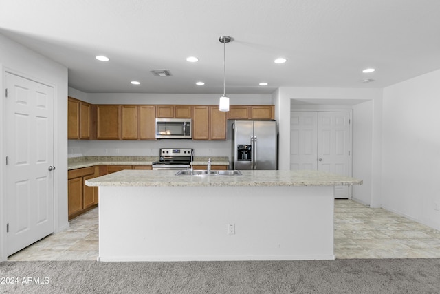 kitchen featuring light carpet, appliances with stainless steel finishes, sink, decorative light fixtures, and an island with sink