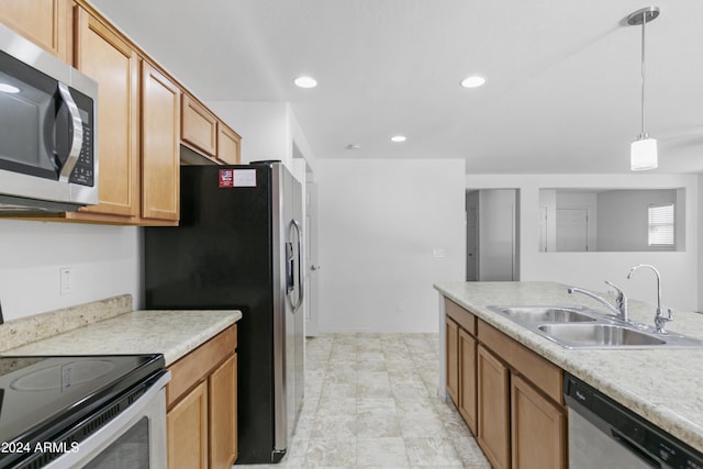 kitchen with pendant lighting, sink, and stainless steel appliances