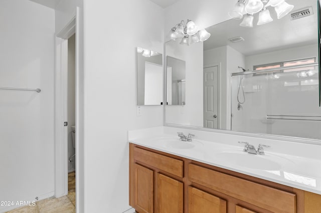 bathroom featuring tile patterned flooring, vanity, and walk in shower