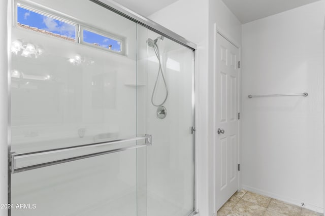 bathroom featuring a shower with door