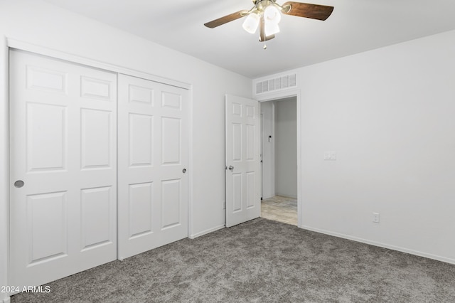 unfurnished bedroom with carpet floors, a closet, and ceiling fan