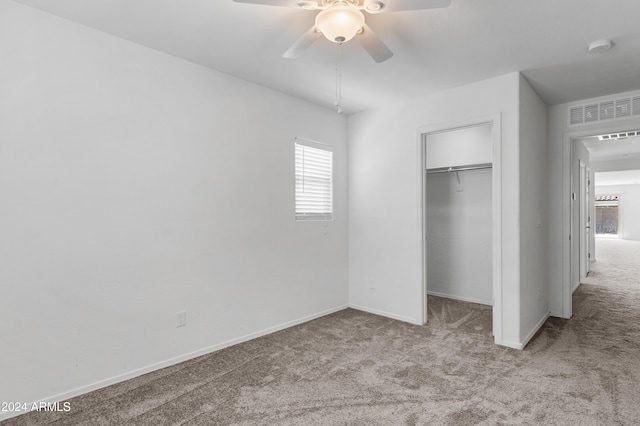 unfurnished bedroom with ceiling fan, a closet, and light colored carpet