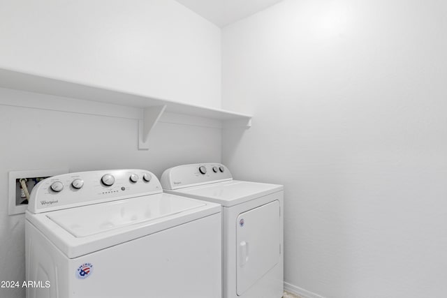 clothes washing area with separate washer and dryer