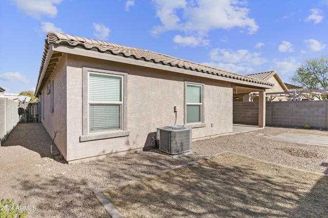 back of property with a patio and central air condition unit