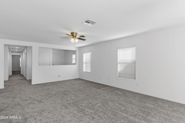 carpeted spare room with ceiling fan