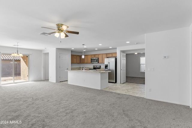 kitchen with hanging light fixtures, plenty of natural light, stainless steel appliances, and ceiling fan with notable chandelier