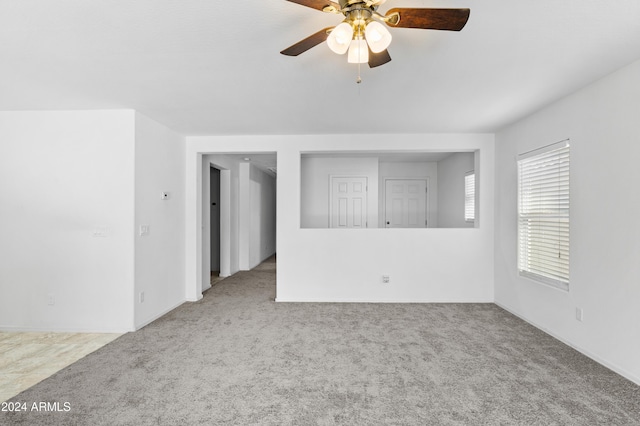 empty room with light colored carpet and ceiling fan