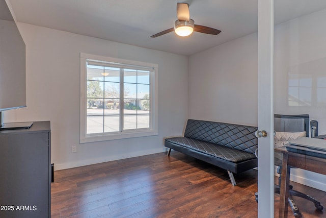 living area with a ceiling fan and wood finished floors