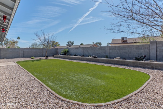 view of yard with a fenced backyard