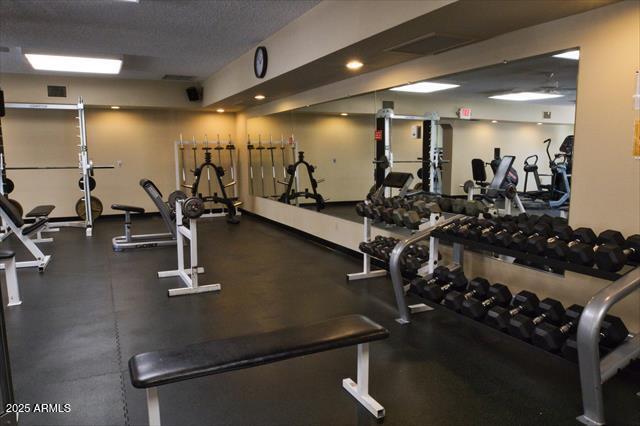 gym featuring a textured ceiling