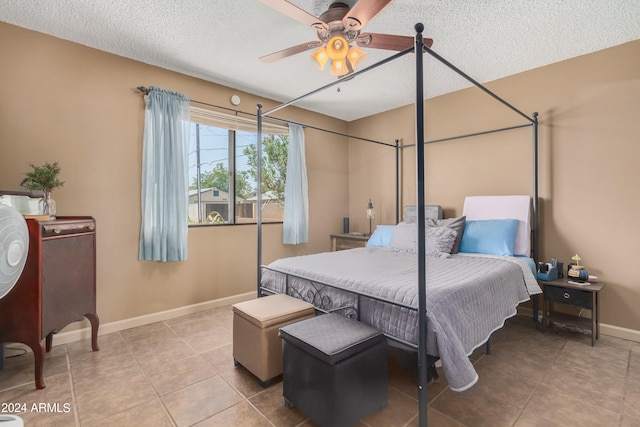 bedroom with tile patterned floors, a textured ceiling, and ceiling fan