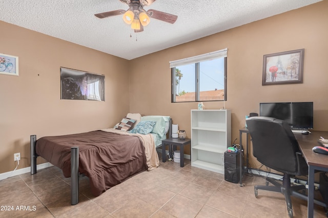 bedroom with light tile patterned flooring, a textured ceiling, and ceiling fan