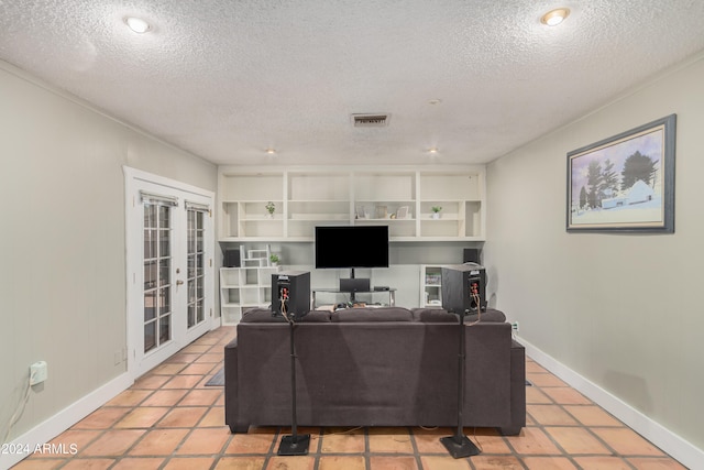 office area with a textured ceiling, french doors, and light tile patterned floors