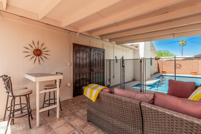 view of patio with ceiling fan, a bar, an outdoor living space, and a fenced in pool