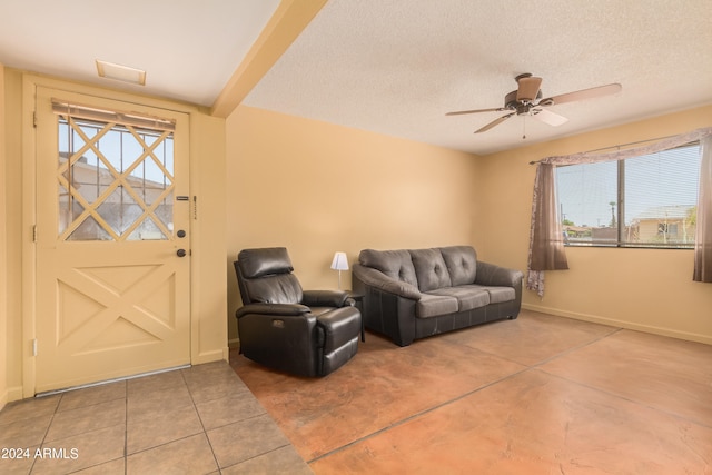 living room with a textured ceiling, a healthy amount of sunlight, and ceiling fan