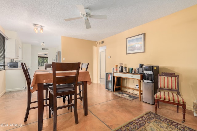 dining area featuring a textured ceiling and ceiling fan