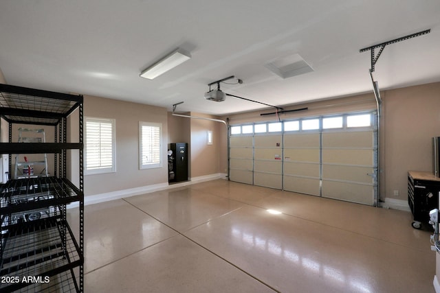 garage with a garage door opener and baseboards