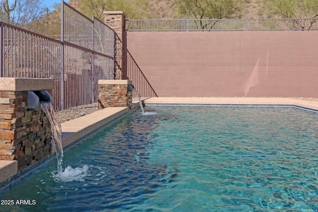 view of pool with a fenced backyard