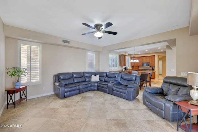 living room featuring ceiling fan, recessed lighting, visible vents, and baseboards