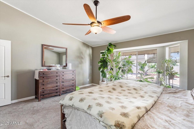 carpeted bedroom with baseboards, lofted ceiling, and a ceiling fan