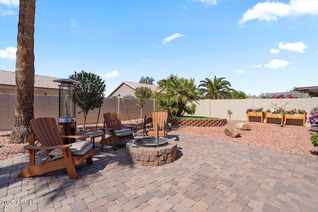 view of patio / terrace featuring an outdoor fire pit and a fenced backyard