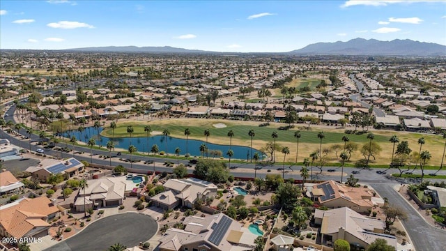 birds eye view of property featuring a residential view, a water and mountain view, and view of golf course