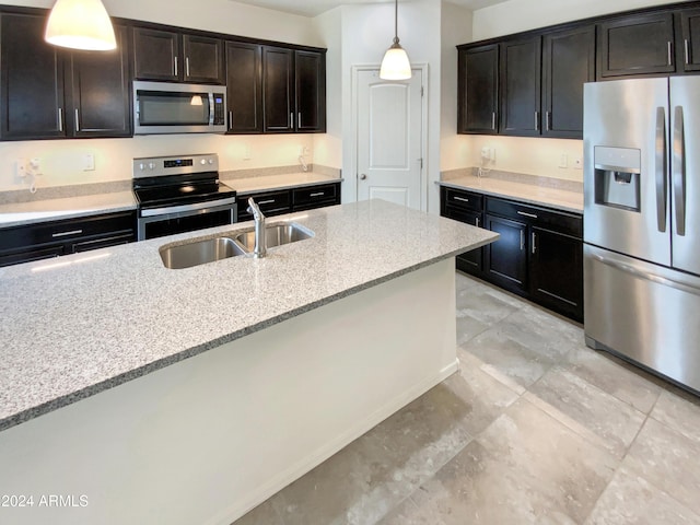 kitchen with dark brown cabinetry, light stone countertops, sink, pendant lighting, and appliances with stainless steel finishes