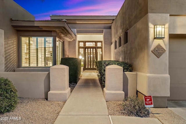 view of exterior entry at dusk