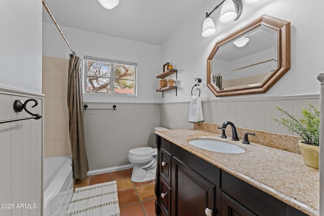 full bath with toilet, shower / tub combo with curtain, wainscoting, tile patterned floors, and vanity