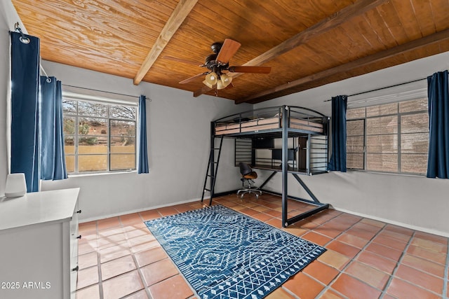 tiled bedroom with wooden ceiling, baseboards, and beam ceiling