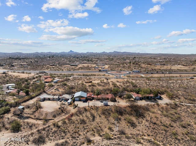 drone / aerial view featuring a desert view and a mountain view