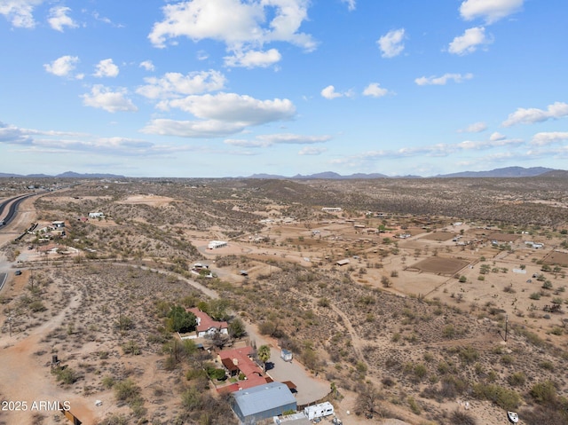 bird's eye view with a mountain view and view of desert