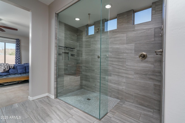 bathroom featuring ceiling fan and a tile shower