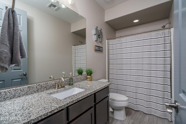 bathroom with toilet, vanity, and a shower with curtain