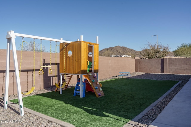 view of play area with a mountain view and a lawn