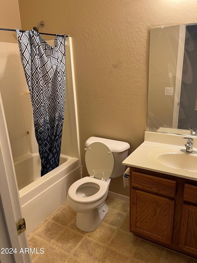 full bathroom with tile patterned flooring, shower / bath combo with shower curtain, vanity, and toilet