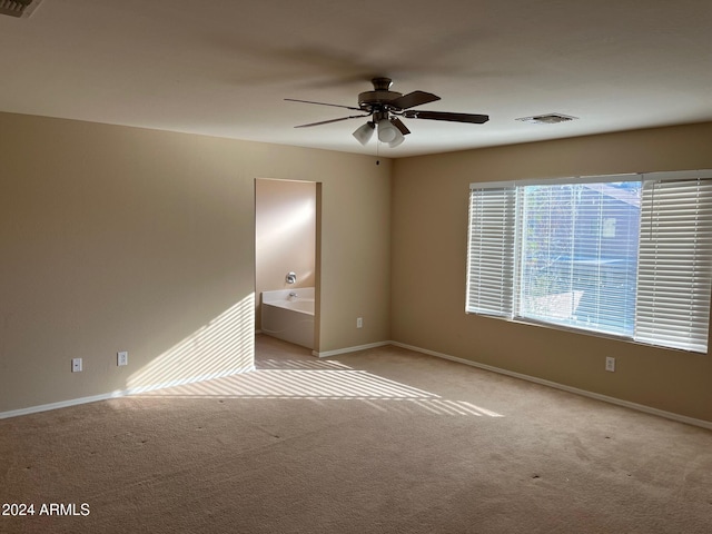 carpeted empty room featuring ceiling fan