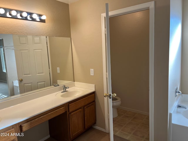 bathroom with vanity and toilet