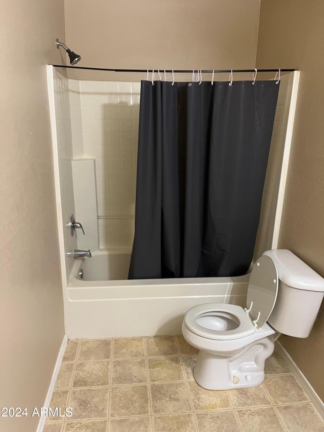 bathroom with shower / bath combo and toilet