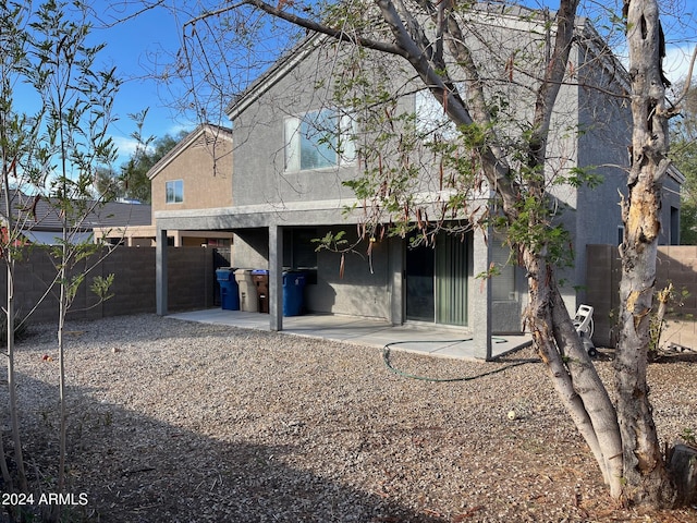 back of property with a patio