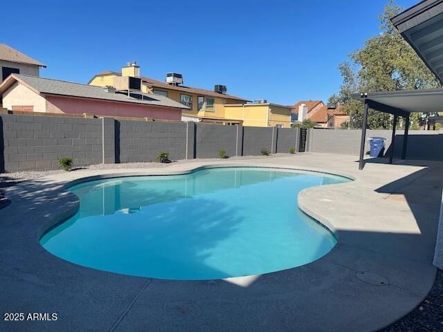 view of swimming pool with a fenced in pool, a fenced backyard, and a patio