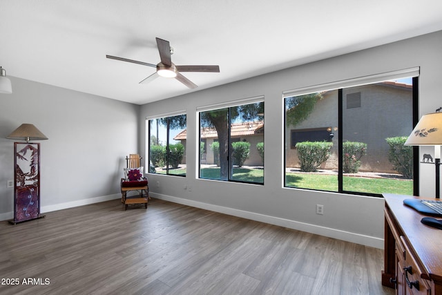 347 Leisure World, Mesa, AZ 85206 - living area with a ceiling fan, wood finished floors, and baseboards