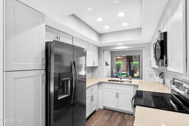 347 Leisure World, Mesa, AZ 85206 - kitchen with appliances with stainless steel finishes, a sink, light countertops, white cabinetry, and backsplash