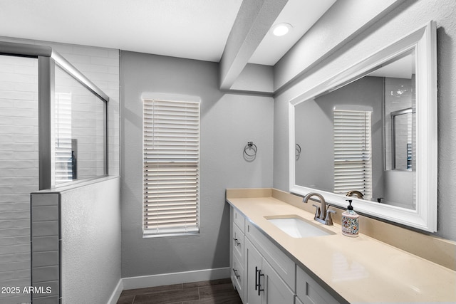 347 Leisure World, Mesa, AZ 85206 - bathroom featuring vanity, tiled shower, wood finished floors, baseboards, and healthy amount of natural light
