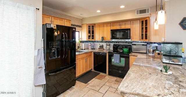 kitchen featuring black appliances, crown molding, hanging light fixtures, decorative backsplash, and light stone counters