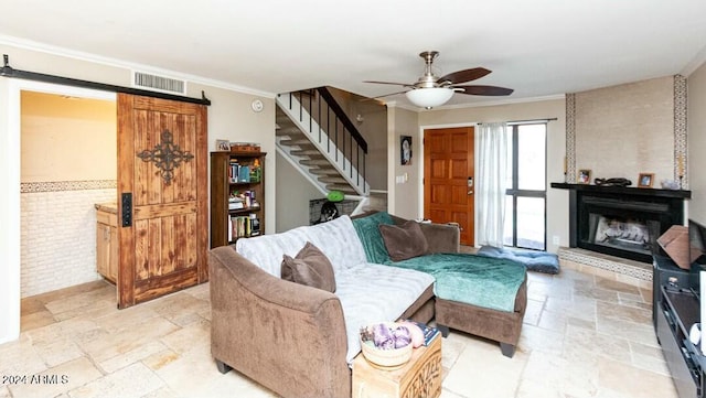 living room featuring ceiling fan, brick wall, and ornamental molding