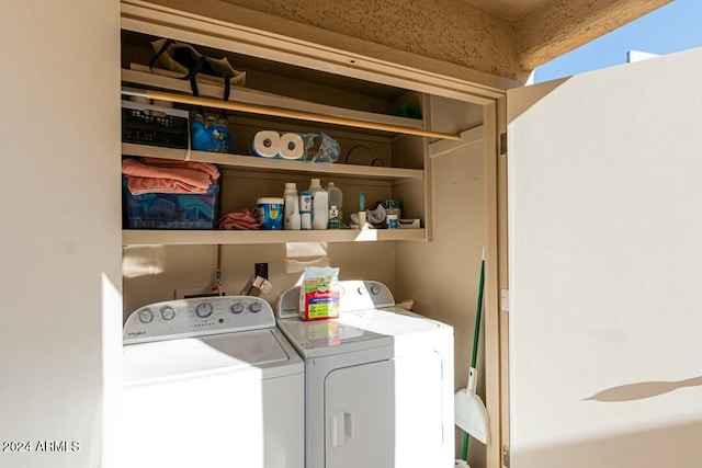 clothes washing area with washing machine and dryer