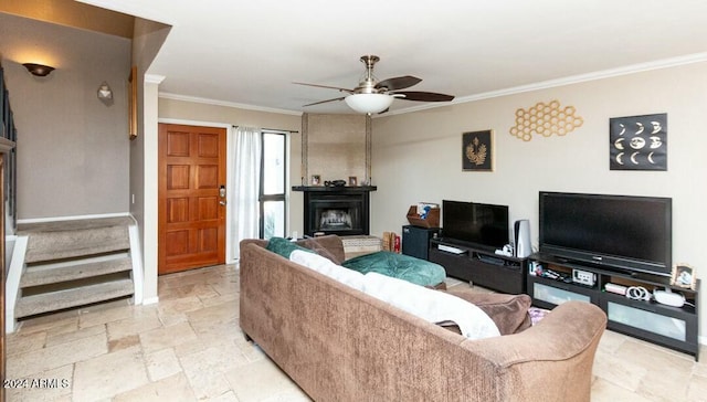 living room with a fireplace, ceiling fan, and crown molding