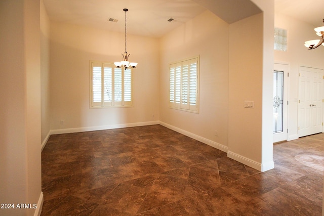 spare room with a chandelier