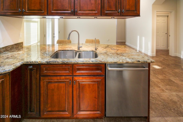 kitchen featuring sink, stainless steel dishwasher, kitchen peninsula, and light stone countertops